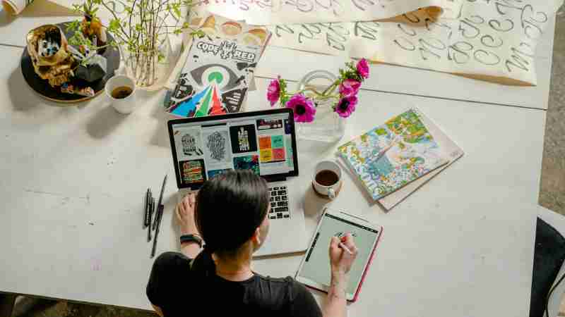 Artistic workspace featuring calligraphy and digital design on a tablet and laptop., tags: digitale nederlandse - pexel