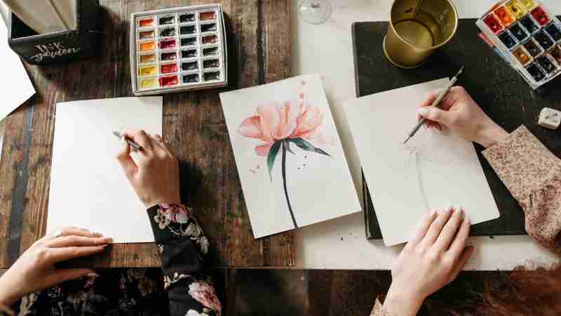 Overhead view of artists drawing floral designs with watercolors and pencils, indoors., tags: textuur en - pexel